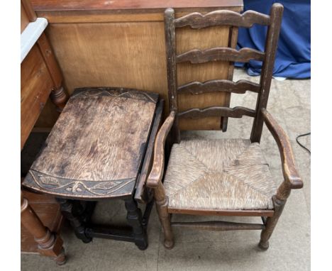 A child's ladder back chair together with a small table with a carved top 
