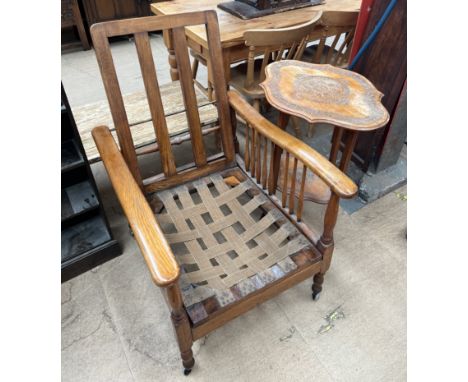 A reclining chair with stick supports together with a continental carved occasional table 