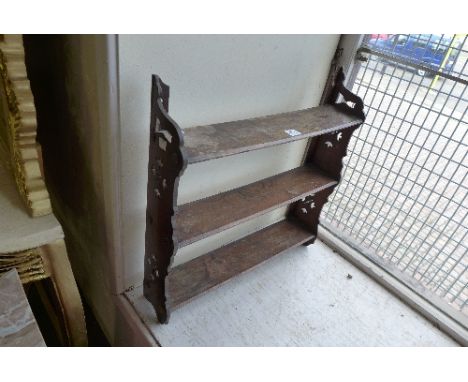 A small mahogany wall shelf