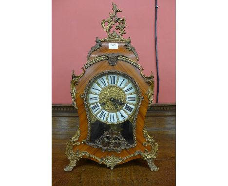 A French Louis XV style rosewood effect and gilt metal bracket clock, with German movement