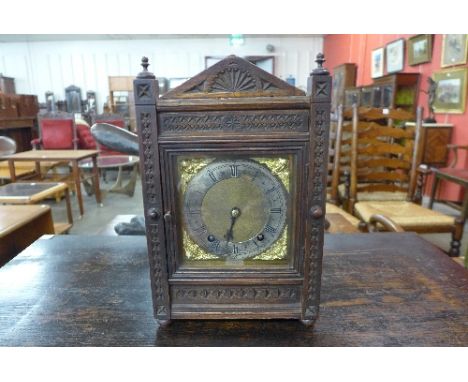 A Victorian carved oak bracket clock