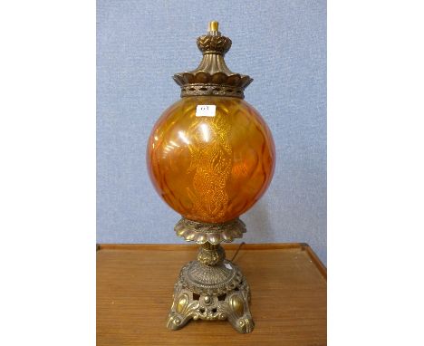 A brass and orange glass table lamp