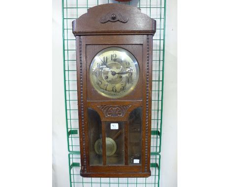 An oak wall clock and a mahogany wall clock