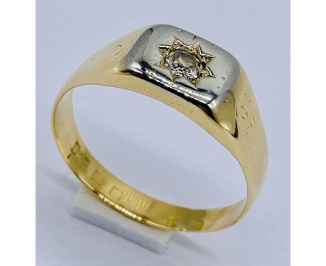 An 18ct gold ring set with a diamond, weight 5.8g, size T 1/2
