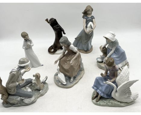A collection of various Nao figurines along with a USSR otter 