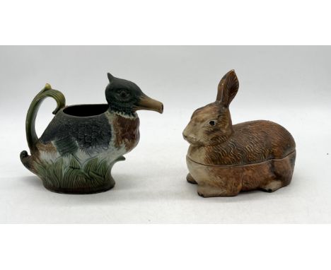 An antique Majolica pitcher in the form of a duck, marked CR to base along with a similar style terrine in the form of a rabb