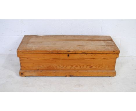 A small antique pine trunk, with iron handles - length 94cm, depth 38.5cm, height 29.5cm