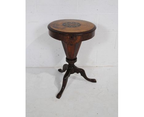 A Victorian inlaid walnut and mahogany sewing table, raised on octagonal tripod base