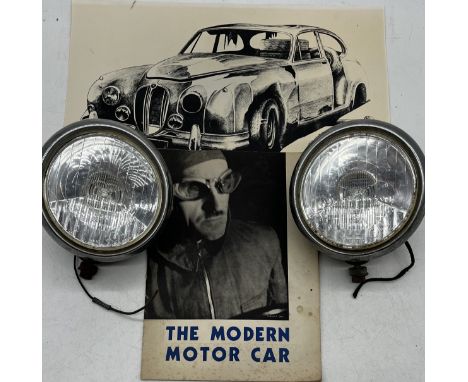 Two large vintage Cibie car spotlights along with a copy of "The Modern Motor Car" by Shell-Mex and BP Ltd, from the 1930s wi