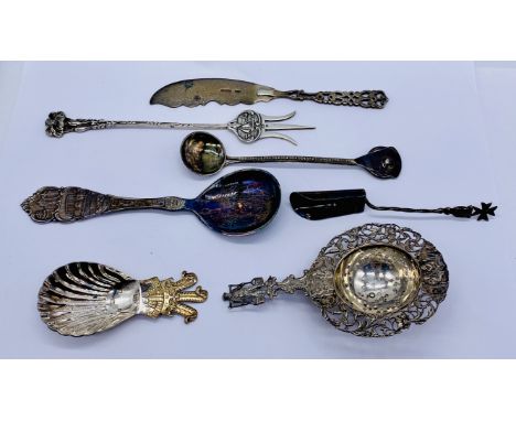 A small collection of continental and hallmarked silver including a tea strainer, caddy spoon etc.