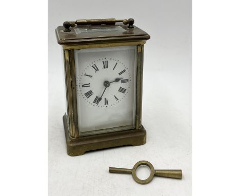 A brass cased carriage clock with key