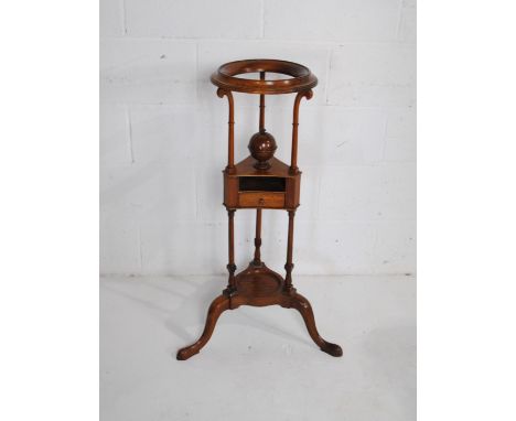 A Georgian oak plant stand, with central ball finial revealing storage inside and single drawer under, with turned supports, 