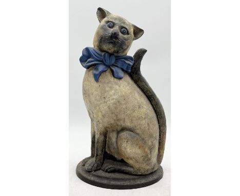 An early 20th century cast iron door stop modelled as a cat wearing a bow tie, stamped Nestor to base