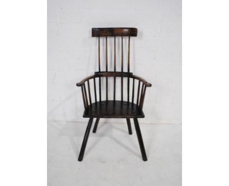 An antique elm and ash Welsh comb back chair, with curved top rail, raised on stick legs