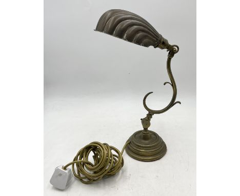 A brass table lamp with shell shaped shade 