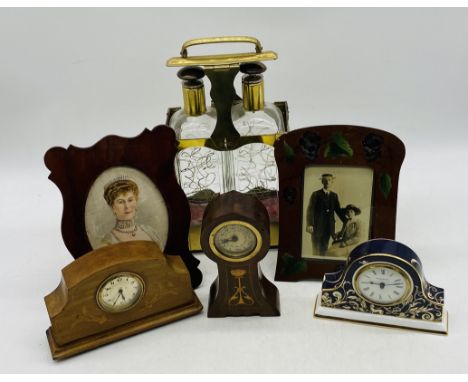 A two-bottle brass framed tantalus, along with two wooden photo frames, two inlaid mantle clocks and a Wedgwood mantle clock.