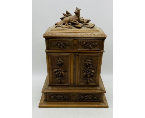 A Black Forest style table top cabinet with six drawers, carved detailing and seated dear finial - deer A/F 