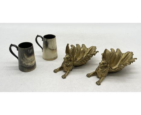A pair of gilt bronze griffins, possibly trinket trays, along with a pair of turned horn cups with metal handles