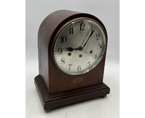 An Edwardian mahogany mantle clock with silvered dial and Arabic numerals