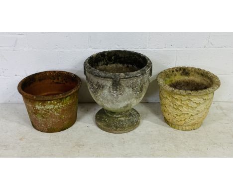 Two large reconstituted stone garden planters along with a large terracotta planter