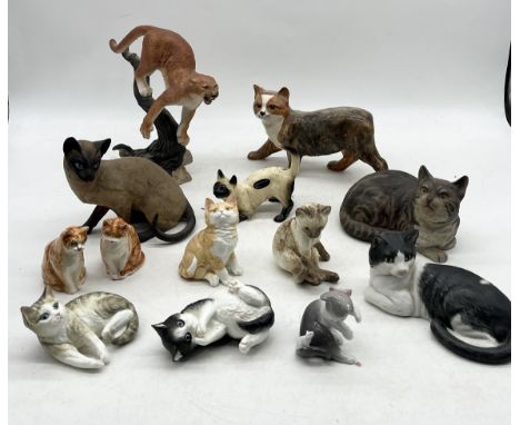 A collection of various cat figurines including Royal Worcester "Kittens", Rushton Pottery, Franklin Mint, Lladro and two sma