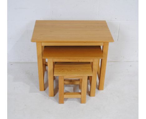 A modern light oak nest of three tables