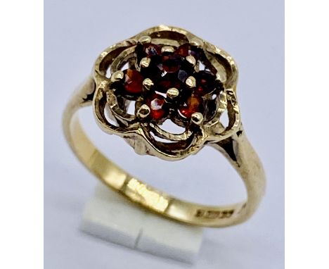 A garnet cluster ring set in 9ct gold, size J