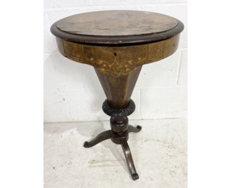 An inlaid walnut veneered Victorian sewing box on tripod legs