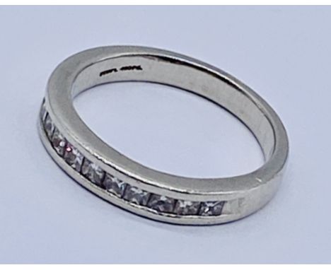 A platinum half eternity ring set with diamonds. The ring comes with a gemologist report from the Independant Gemological Lab