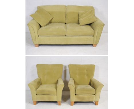 A light green upholstered three piece suite, comprising of a two seater sofa and a pair of armchairs - sofa length 183cm