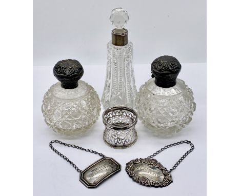 A collection of hallmarked silver including Whisky and Port decanter labels, three silver topped cut glass scent bottles and 