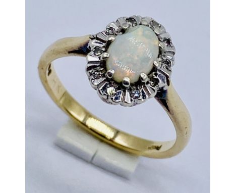 A 9ct gold opal and diamond cluster ring, size M 1/2