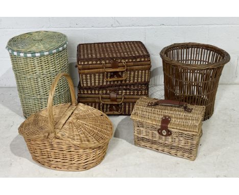 A collection of various wicker baskets including two picnic hampers, vintage waste paper basket etc.