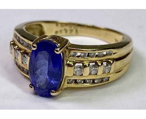 18CT GOLD TANZANITE &amp; DIAMOND RING - 1.99ct claw set oval central stone, 10 x 6mm, with three inline rows of 13 small dia