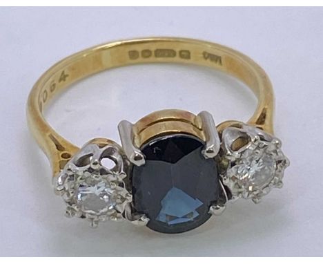 18CT GOLD &amp; PLATINUM 3 STONE DARK BLUE SAPPHIRE &amp; DIAMOND RING - 9 x 7mm the central stone, flanked by 2 x 0.20ct dia