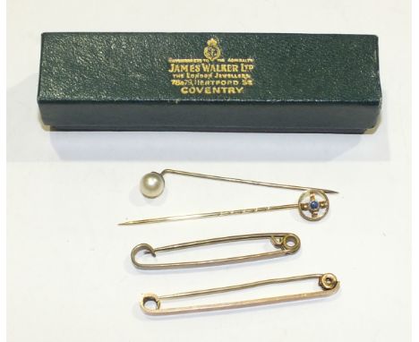 An Edwardian stick pin set a sapphire in 9ct gold mount, 0.9g, a 9ct gold tie pin, 2.4g (gross) and two other pins, (4). 