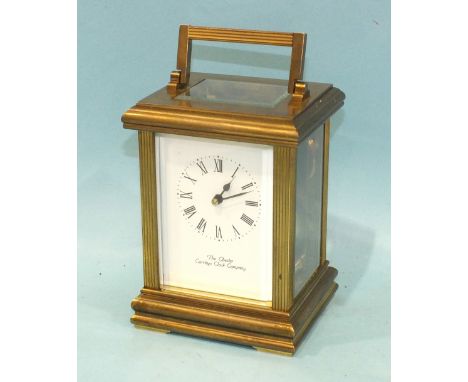 A modern brass carriage clock with bell-striking movement, the case with reeded pillars, enclosing a white enamel dial, "The 