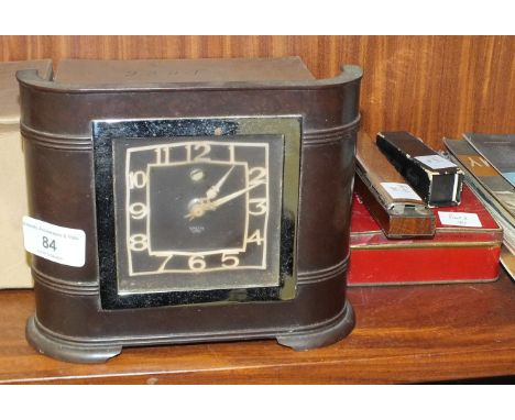 A Smiths Bakelite electric Art-Deco-style mantel clock, 18cm wide, 15cm high, an MGM Trichordi harmonica, a set of dominoes, 