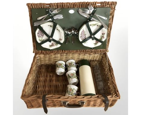 A wicker picnic hamper and contents 