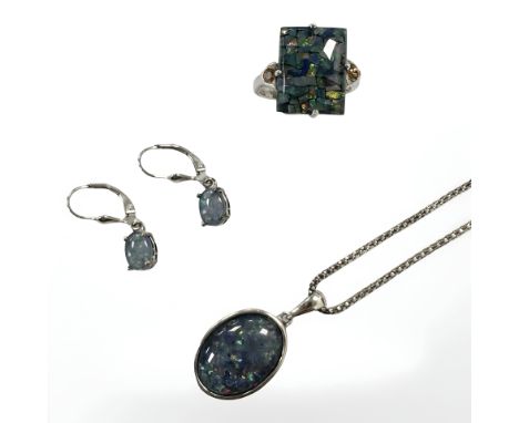 A sterling silver necklace with synthetic opal pendant together with matching dress ring and pair of earrings 
