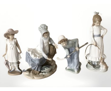 Three Nao figures of children including boy with hockey stick, girl with hoop and a further Spanish figure.