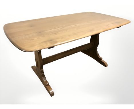 An Ercol stained elm refectory dining table, 150 cm x 84 cm x 72 cm, together with a matching set of six spindle back dining 