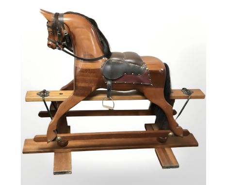 A modern wooden rocking horse, length 145 cm 