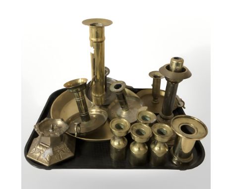 An oversized brass chamber stick plus smaller examples, set of four candlesticks, pricket candlestick, etc.