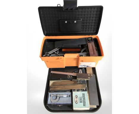 A group of folding rules, precision caliper, tool box containing similar items  