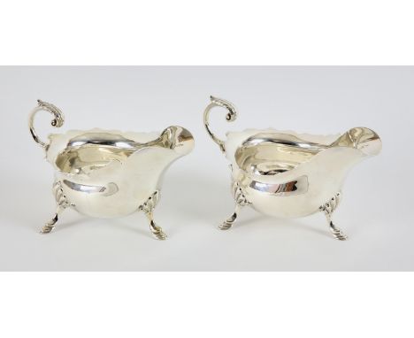 Pair of silver gravy boats with scroll handles on hoof feet, by Walker & Hall, 13ozt 407gm