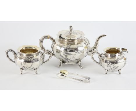 Early 20th century Chinese silver tea service by Wang Hing, with raised decoration of three clawed dragons, birds and insects