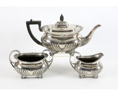 Late Victorian half reeded three piece silver tea service with gadrooned rim on scrolling paw feet, by Thomas Bradbury & Sons