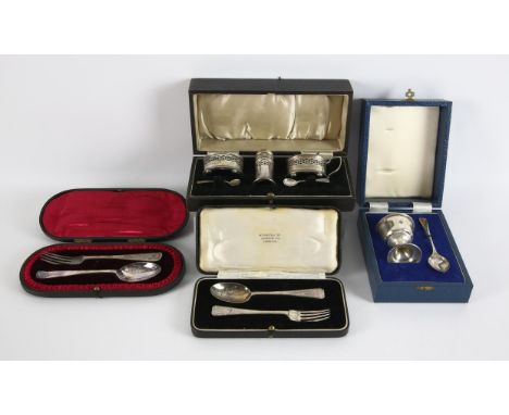 Cased three piece silver condiment set with non matching spoons, cased egg cup and spoon, and two cased pairs of spoons and f