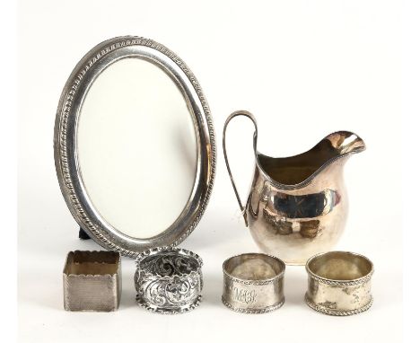 Silver cream jug Chester 1928, three napkin rings and an oval picture frame, weighable silver 7.4ozt 232gm Sold on behalf of 